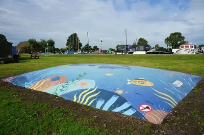 a painting of a fish on the ground in a field at EuroParcs Kagerplassen in Warmond