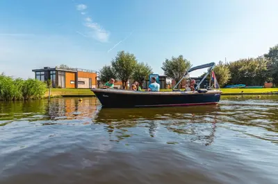 a group of people in a boat on the water at EuroParcs Kagerplassen in Warmond