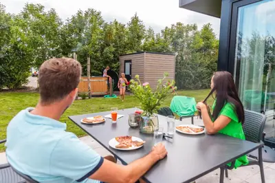 a man and a woman sitting at a table at EuroParcs Kagerplassen in Warmond