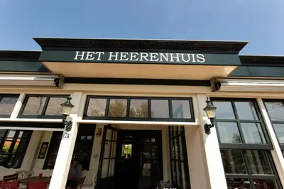 a building with a sign that reads hot herbertitus at Café Brasserie Het Heerenhuis in Het Kalf