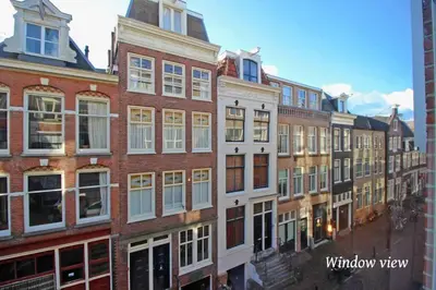 a row of brick buildings in a city at Luxurious boutique suite in City Center in Amsterdam