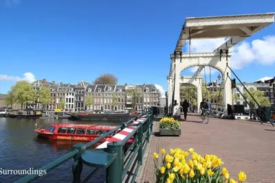 a boat on a river next to a bridge at Luxurious boutique suite in City Center in Amsterdam
