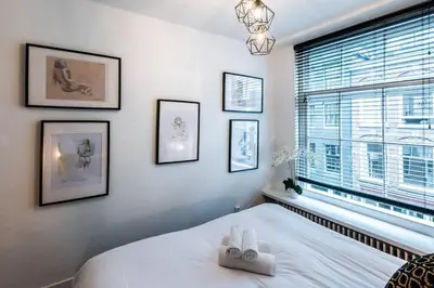a bedroom with a bed with two white towels on it at Luxurious boutique suite in City Center in Amsterdam
