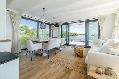 a living room with a white couch and a table at Surla houseboat 