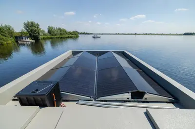 a boat with a solar panel on the water at Surla houseboat 