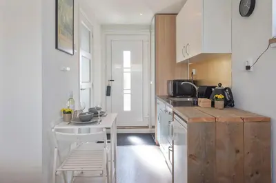 a kitchen with a table and a white counter top at Forest and Ocean in Zandvoort