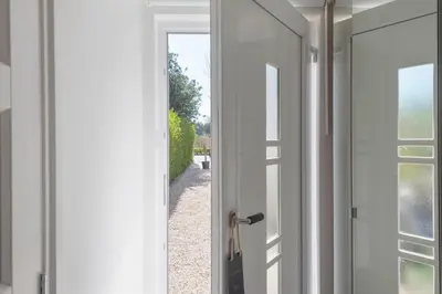 an open door with a view of a yard at Forest and Ocean in Zandvoort