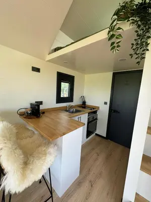 a kitchen with a counter top and a sink at TinyHouse Noorderlicht in Haastrecht