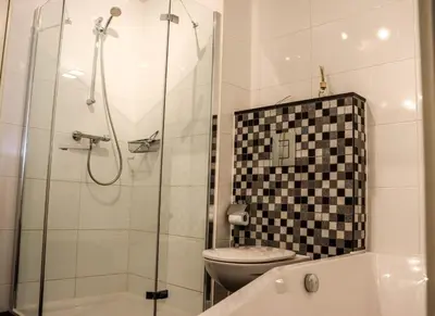 a bathroom with a toilet and a glass shower at Atlantis 15b in Egmond aan Zee