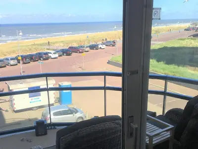 a view of a parking lot with a car parked at Atlantis 15b in Egmond aan Zee
