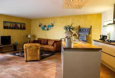 a kitchen and a living room with a couch at Atlantis 15b in Egmond aan Zee