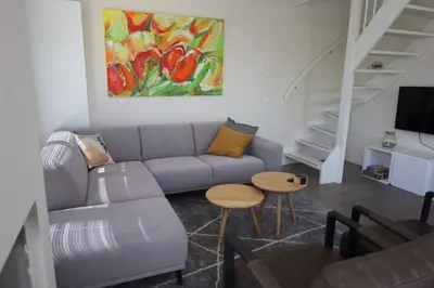 a living room with a couch and a table at Villa Zon & Duin in Egmond aan den Hoef