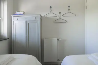 a bedroom with two lights on the wall at Villa Zon & Duin in Egmond aan den Hoef