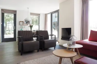a living room with two chairs and a couch at Villa Zon & Duin in Egmond aan den Hoef