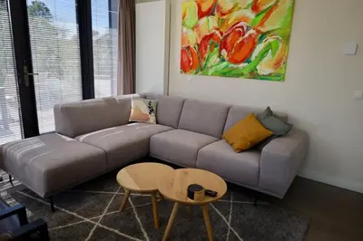 a living room with a couch and a table at Villa Zon & Duin in Egmond aan den Hoef