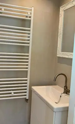 a white bathroom with a sink and a mirror at Sunny Side Up in Egmond aan Zee