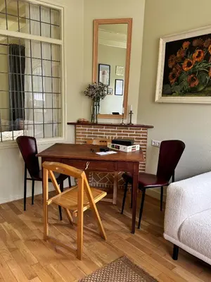 a living room with a wooden table and chairs at Sunny Side Up in Egmond aan Zee
