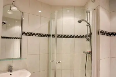 a bathroom with a shower and a sink at Sea la Vie in Egmond aan Zee