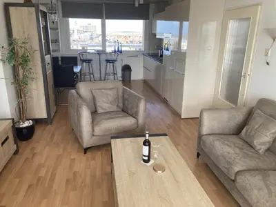 a living room with two chairs and a coffee table at het Zeehuisje in Egmond aan Zee
