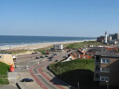 a view of a beach and the ocean from a building at het Zeehuisje in Egmond aan Zee