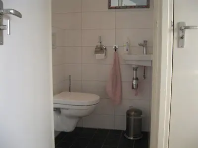 a bathroom with a toilet and a sink at het Zeehuisje in Egmond aan Zee
