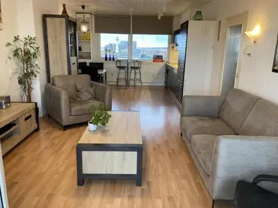 a living room with a couch and a coffee table at het Zeehuisje in Egmond aan Zee