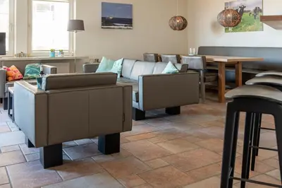 a living room with a couch and a table at Atlantis 14b in Egmond aan Zee