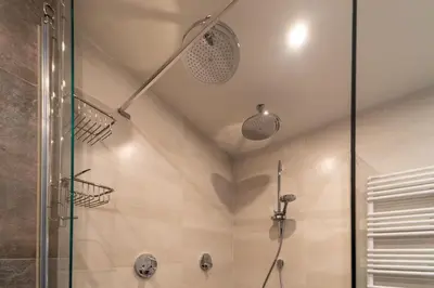 a bathroom with a shower with a glass door at Atlantis 14b in Egmond aan Zee