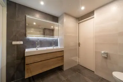 a bathroom with a sink and a mirror at Atlantis 14b in Egmond aan Zee