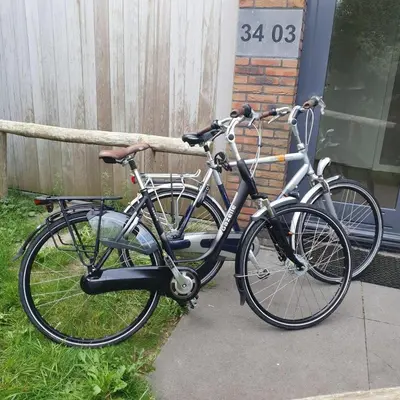 two bikes are parked next to a house at Villa Duinhuis Zee in Egmond aan den Hoef
