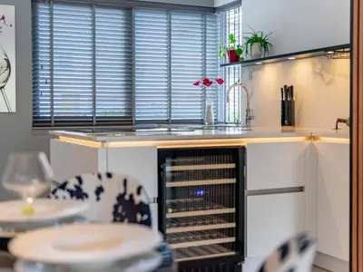a kitchen with a sink and a wine rack at Alkmaar aan het Water in Alkmaar
