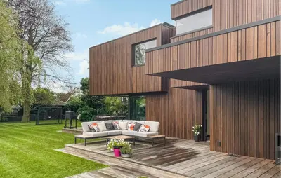 a house with a wooden deck with two couches at Awesome Home In Vinkeveen in Vinkeveen