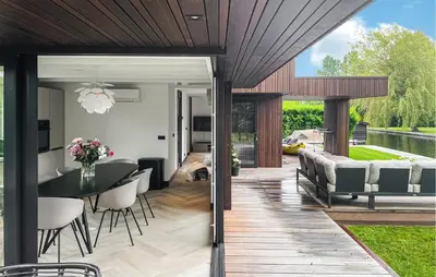 a dining room and living room with a table and chairs at Awesome Home In Vinkeveen in Vinkeveen