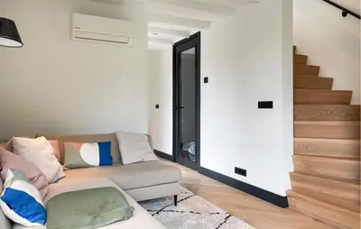 a living room with a couch and a staircase at Awesome Home In Vinkeveen in Vinkeveen