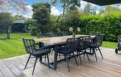 a wooden table and chairs on a wooden deck at Awesome Home In Vinkeveen in Vinkeveen