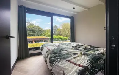a bedroom with a bed and a large window at Awesome Home In Vinkeveen in Vinkeveen