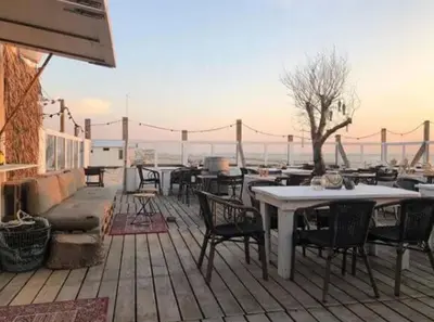 a group of tables and chairs on a patio at Studio Elysium in Bergen