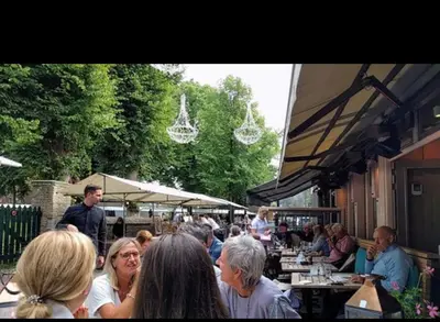 a group of people sitting at an outdoor restaurant at Studio Elysium in Bergen