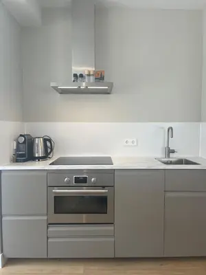 a kitchen with a stove and a sink at Studio Elysium in Bergen