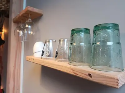 a row of glass jars sitting on a shelf at Waterval Wellness-suite met Sauna! in Bodegraven