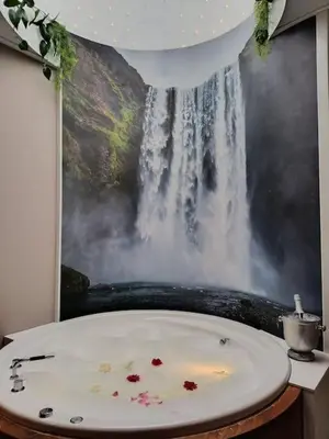 a bathroom with a painting of a waterfall at Waterval Wellness-suite met Sauna! in Bodegraven