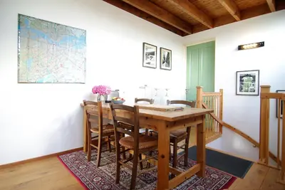 a dining room with a wooden table and chairs at Tranquil wooden house with free parking in Amsterdam