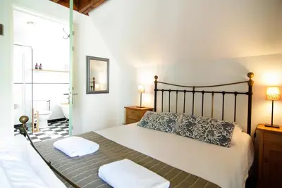 a bedroom with a bed with two towels on it at Tranquil wooden house with free parking in Amsterdam