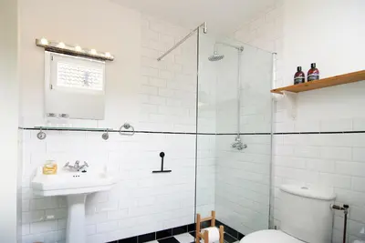 a bathroom with a toilet and a sink at Tranquil wooden house with free parking in Amsterdam