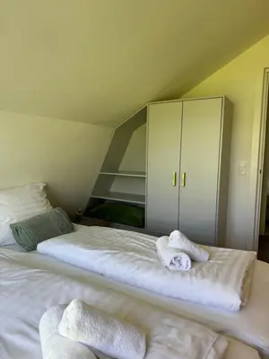 a bedroom with two beds with towels on them at In de Duinpan in Egmond aan den Hoef