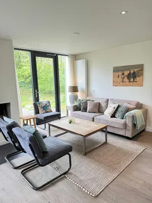 a living room with a couch and a table at In de Duinpan in Egmond aan den Hoef