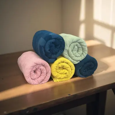 a pile of different colored towels on a table at DomCity Apt Near Amsterdam Bikes Included One mile to City Centre in Utrecht