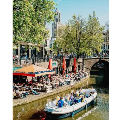 a group of people riding in a boat on a river at DomCity Apt Near Amsterdam Bikes Included One mile to City Centre in Utrecht