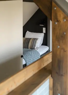 a view of a room with a bed and pillows at B&B Hartenlust kamer de Hooizolder in Bodegraven