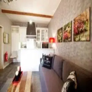a living room with a couch and a kitchen at Group Stay, 7 minutes away from Amsterdam! in Halfweg